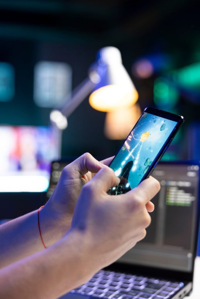 A person holding a phone playing a video game 